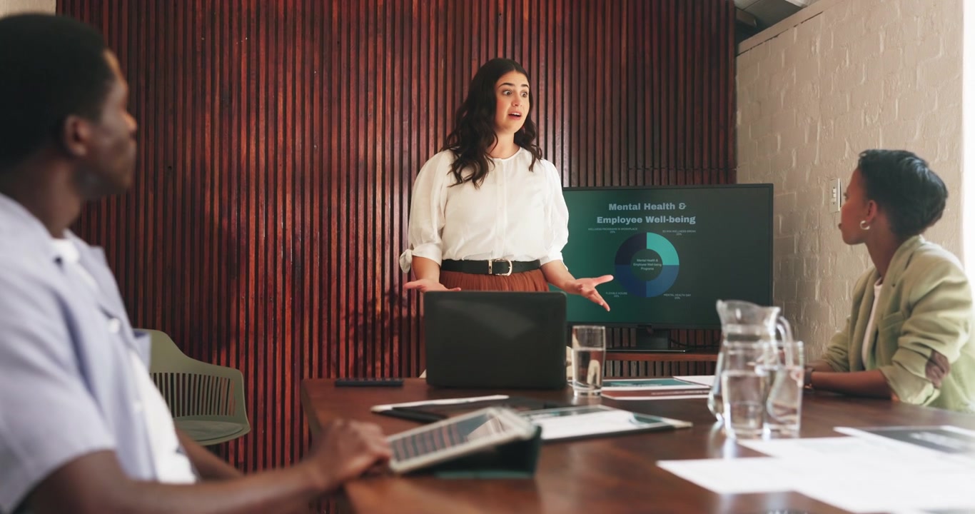 Businesswoman Giving a Presentation on Employee Well-being in a Meeting