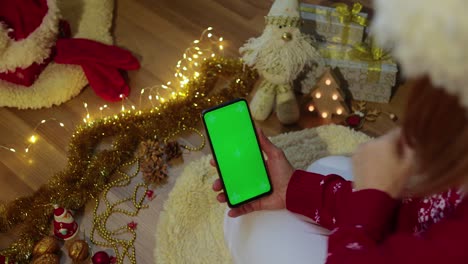 green screen pnone in hands. christmas concept