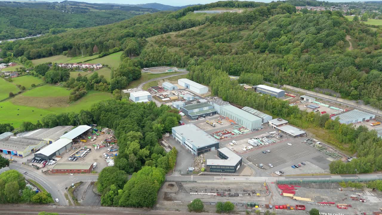 Aerial drone view of industrial buildings and factories among green rolling fields in Ambergate Derbyshire United Kingdom