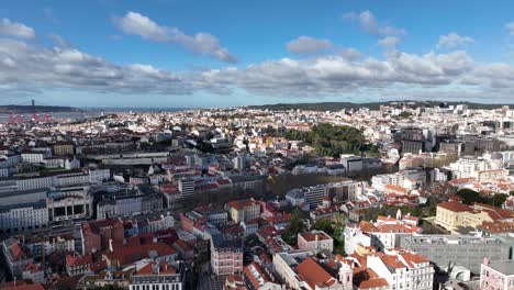 drone shot flying over lisbon with some shadows of the clouds