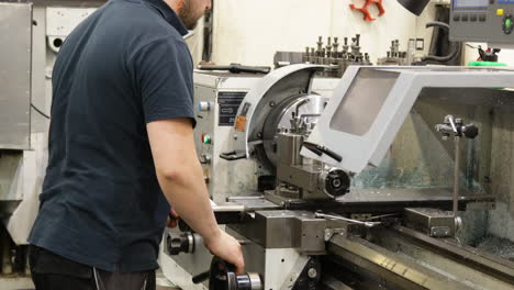 technician working on cnc precision machine inside a factory