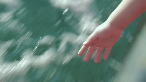 child pulling hand down from sailing boat