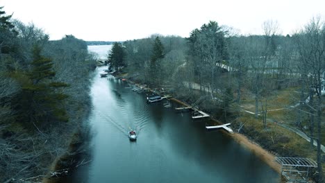 a small fishing boat traveling through a lake michigan tributary