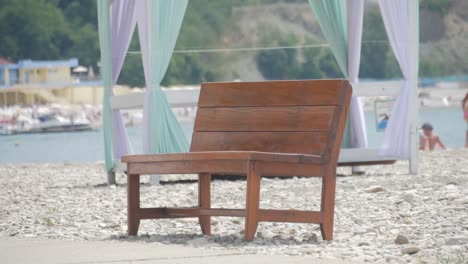 empty bench overlooking a body of water and shoreline.