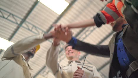 bottom view of multi-ethnic businesspeople putting their hands on top of each other. stack of hands showing unity and teamwork. successful meeting. business and teamwork or teambuilding concept.