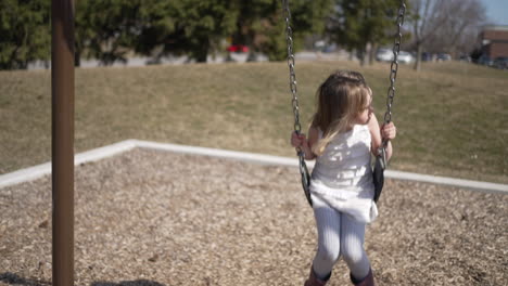 little girl on a swing in slow motion