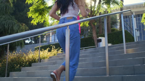 pretty girl ascend on stairs to take picture city. asian woman walking upstairs.