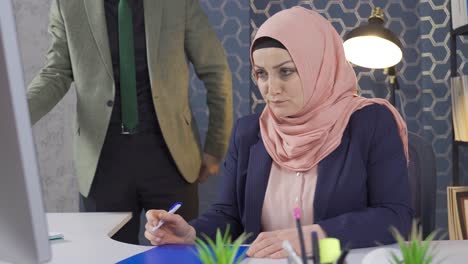 Business-woman-in-hijab-being-scolded-by-her-boss.