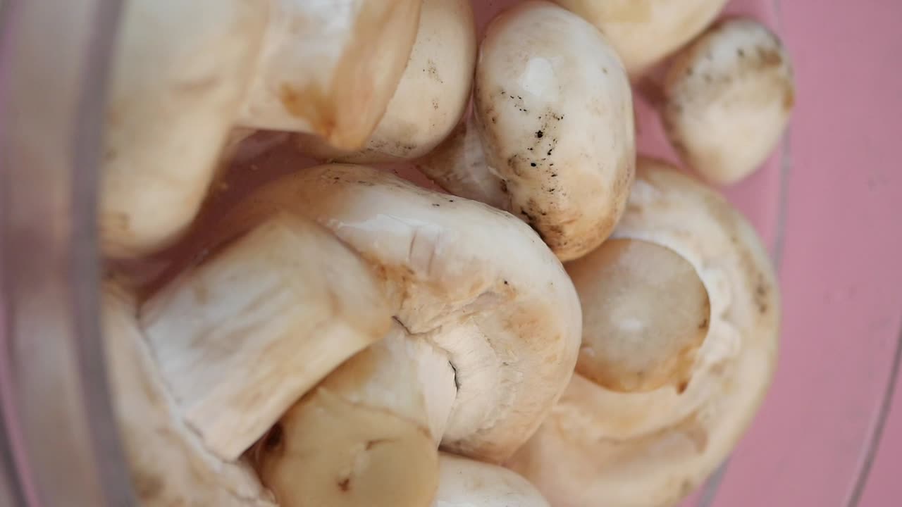 Fresh White Mushrooms in a Glass Bowl