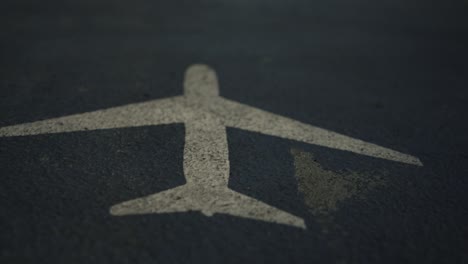 airplane sign painted on airport runway, close up