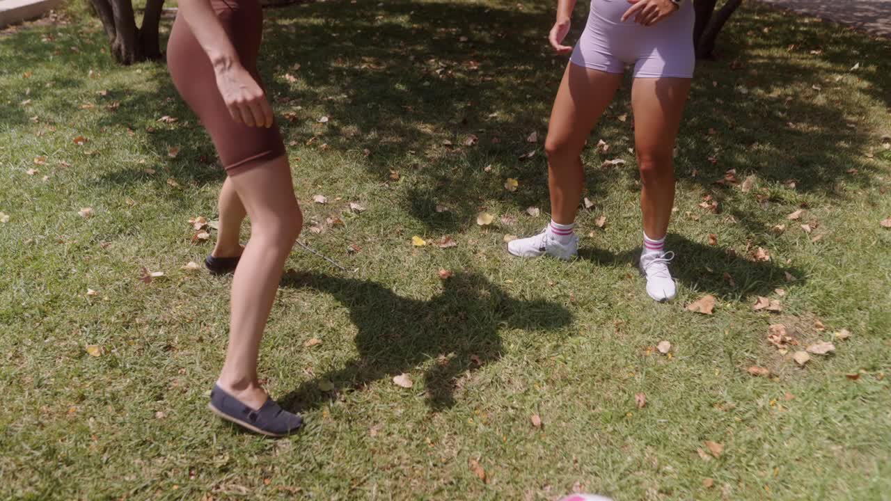 Women playing with a soccer ball outdoors