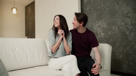 Happy-couple-with-keys-from-their-new-house,-a-man-surprised-wife-with-a-new-apartment