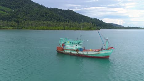 Drone-shot-of-a-wooden-fishing-boat-in-the-sea