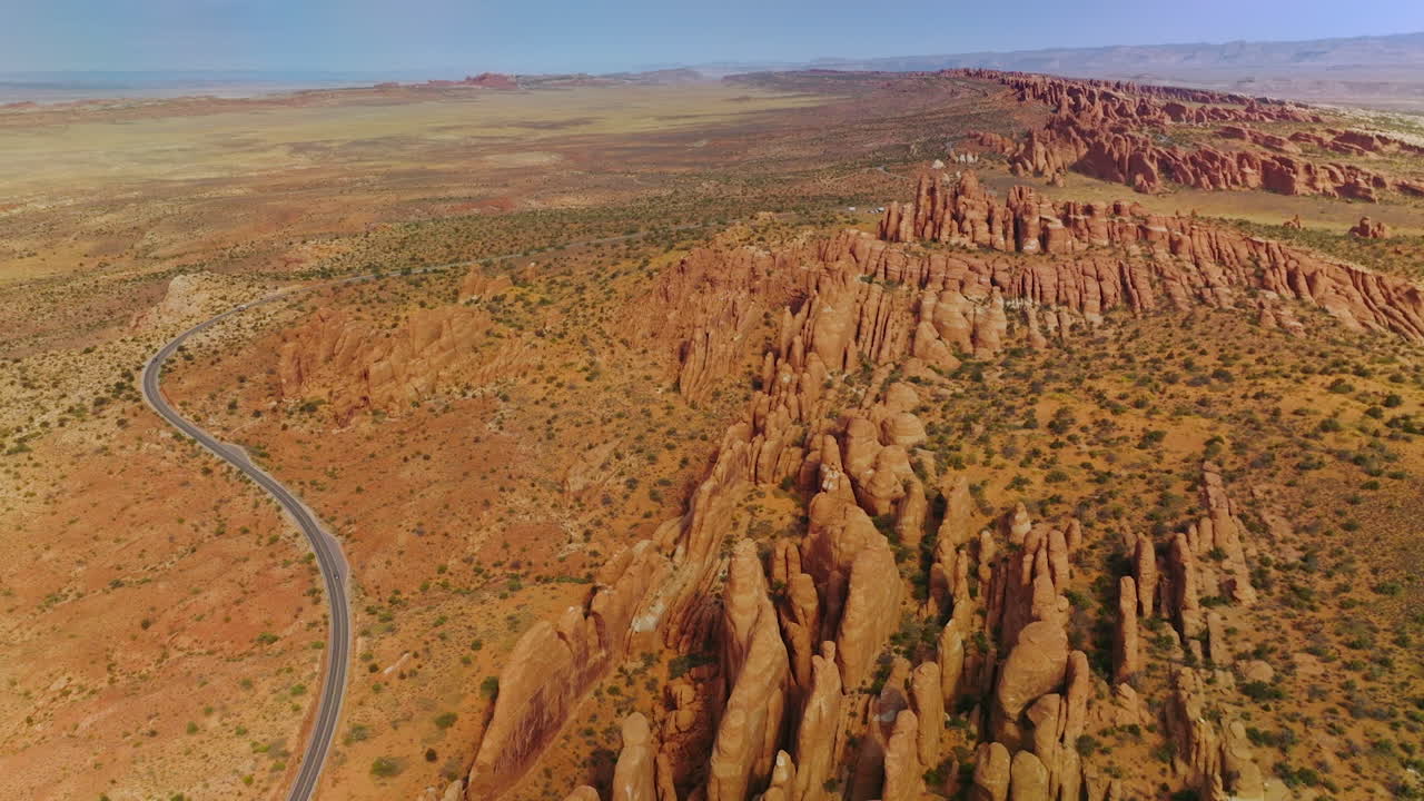Deserted landscape with amazingly-shaped rocks from air erosion. Arches National Park canyons from aerial view.