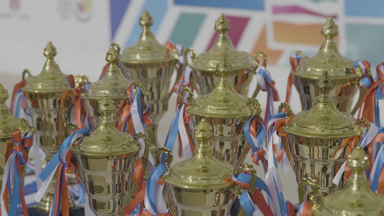 Orbit around trophy stand at finish line of a competitive outdoor race event