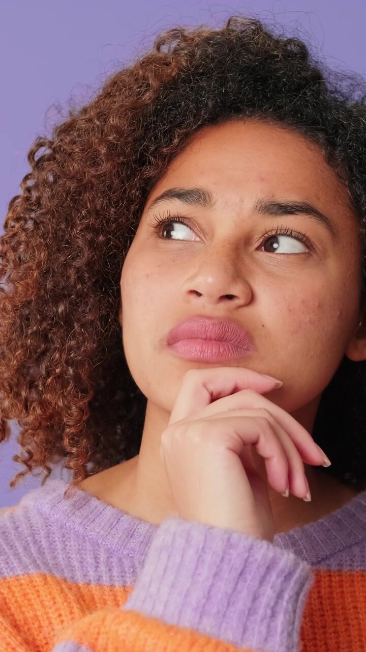 Thoughtful Young Woman Pondering and Looking Away