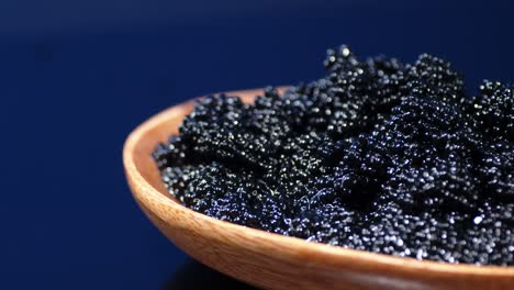 a plate of black caviar rotates slowly.