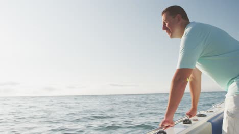 Side-view-of-a-Caucasian-man-on-boat-enjoying-the-sea-view