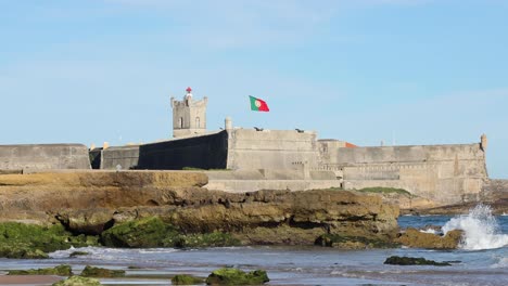 some waves crashing on rocks with fort saint julian