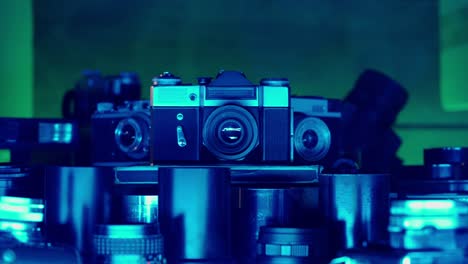 vintage cameras and lenses under blue light