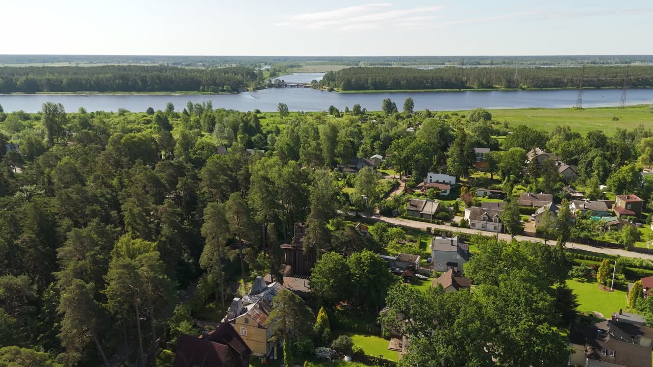 Aerial view of green Jurmala with distant Baltic sea under blue sky