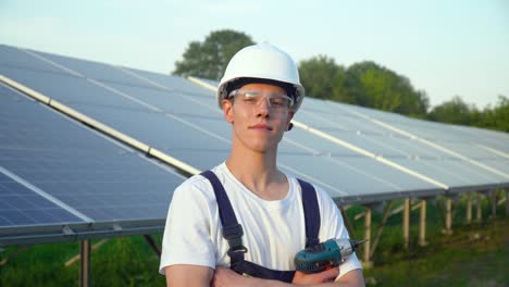 Engineer in a special equipment with screwdriver is at the solar power station. Concept renewable energy