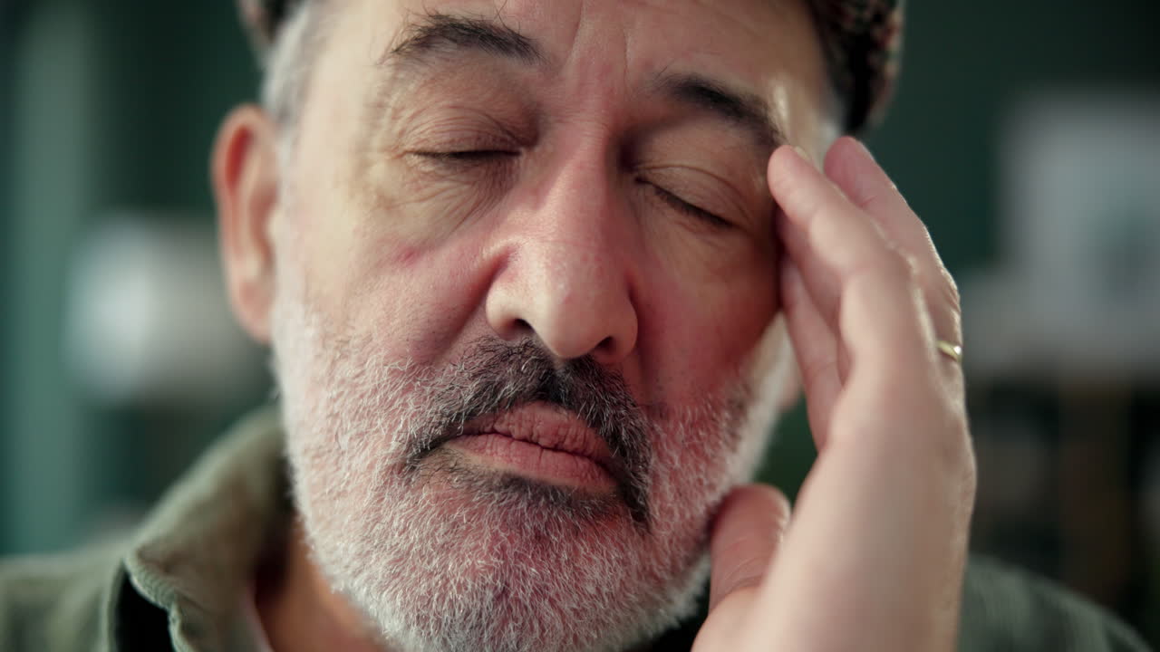 An older man with a headache