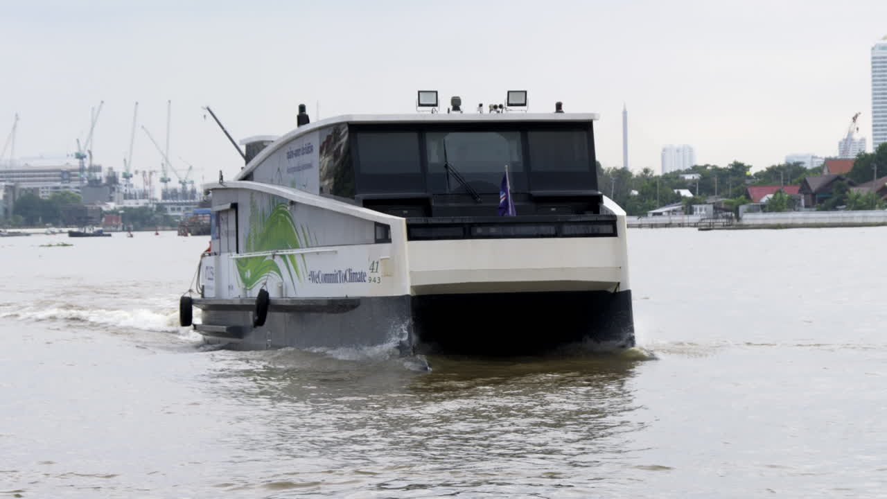 Eco-friendly electric speedboat cruising through the Chao Phraya River in Bangkok, facilitating water transportation for residents and visitors, highlighting sustainable transport options.