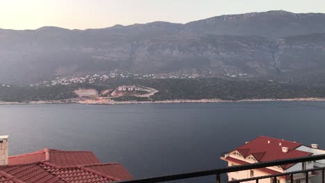 beautiful view of mountains and sea with a sunset from balcony of a villa