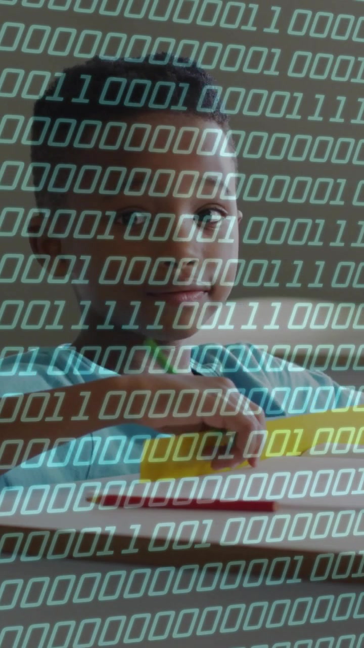 Vertical video: Child bringing green pencil to paper, writing for school, binary overlaying view