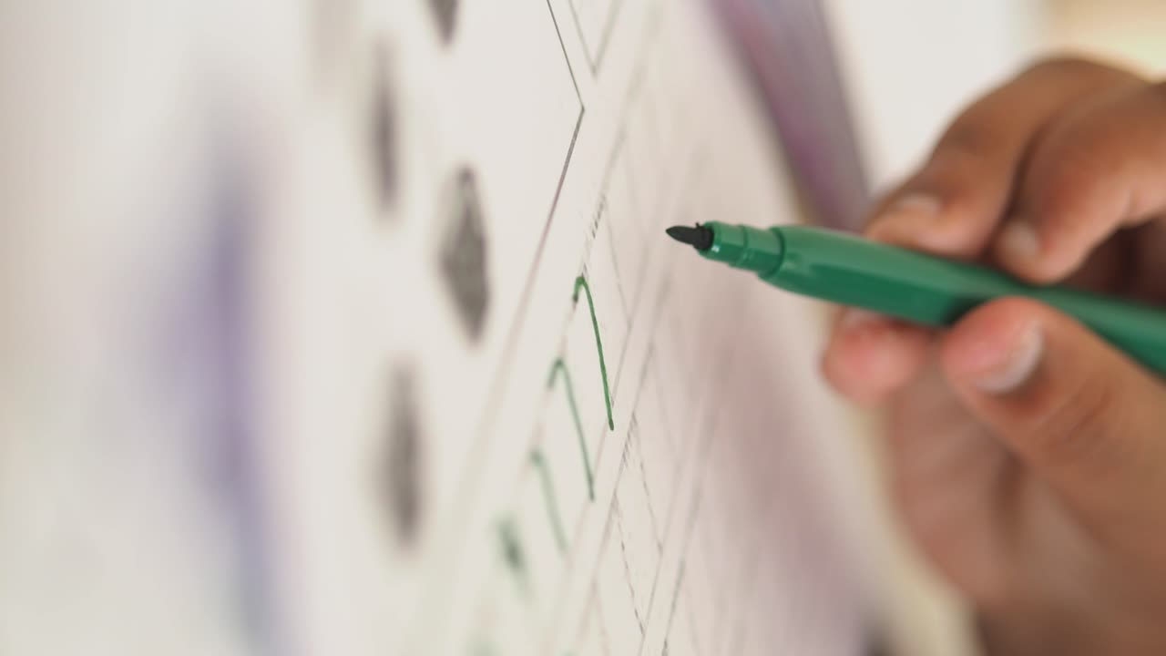 Hand marking checklist with green marker