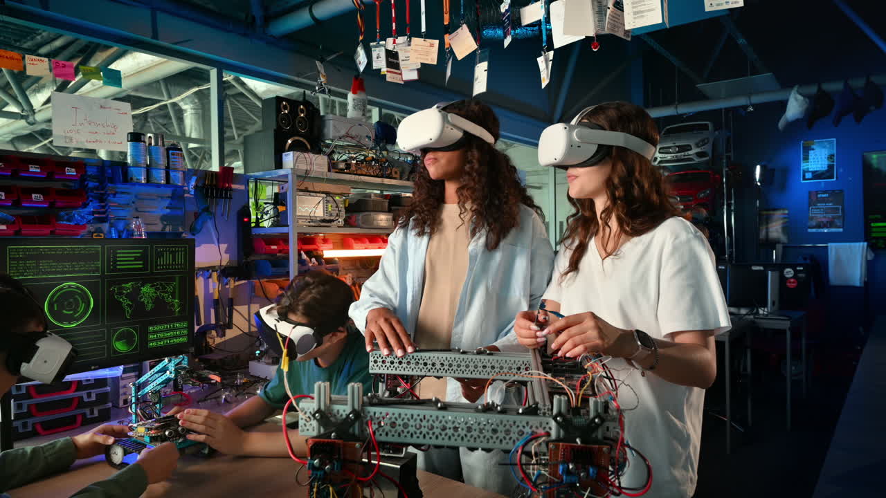 Group of young people in VR glasses doing experiments in robotics in a laboratory. Gesticulating. Robots on the table