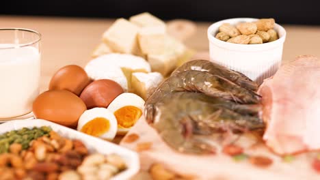 variety of protein-rich foods on wooden surface