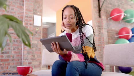 African-american-casual-businesswoman-using-tablet-in-office