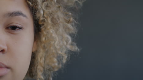 close-up portrait of a young woman with curly blonde hair
