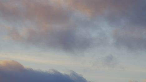 static of soft clouds drifting across a vibrant evening sky, creating a tranquil scenic backdrop, upward angle