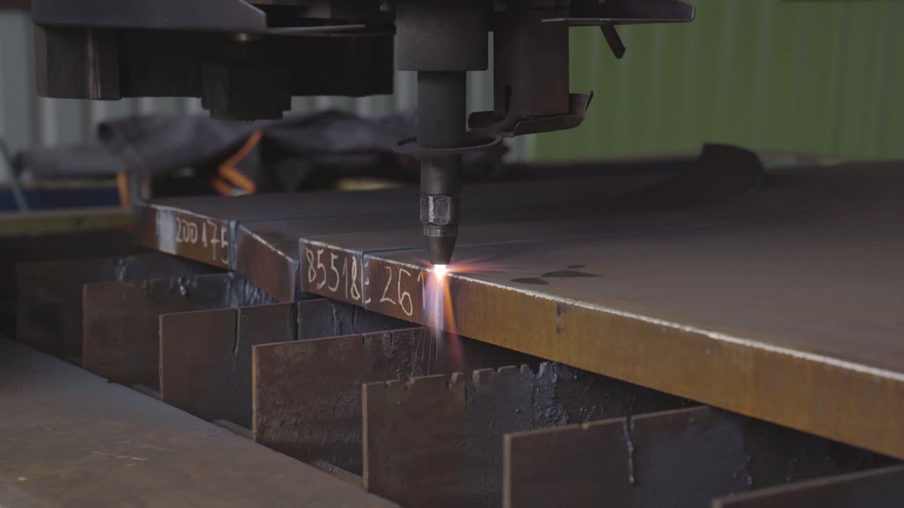 Amazing spark shower as CNC plasma cutter quickly cuts a thick metal workpiece