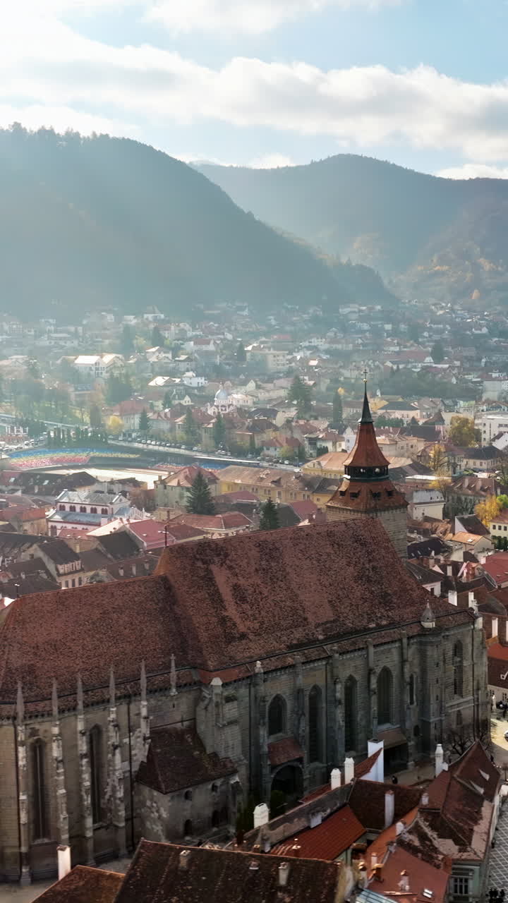 Aerial drone view of the city center of Brasov in south-eastern Transylvania, Romania surrounded by mountains. Vertical