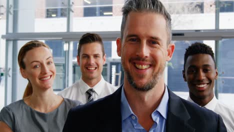 smiling businesspeople standing in office