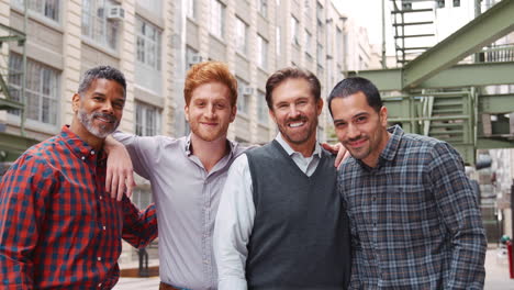 friendly male colleagues hanging out outside their workplace