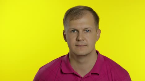 portrait of caucasian man posing in t-shirt. smiling handsome guy show thumb up. people emotions