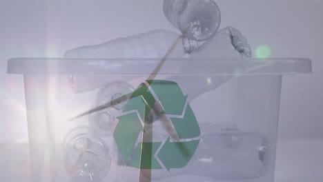 animación de un cartel de reciclaje verde sobre una caja con botellas de plástico y una turbina eólica