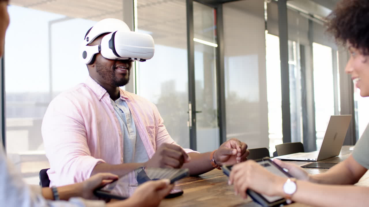 A diverse group of business associates using VR headsets in office