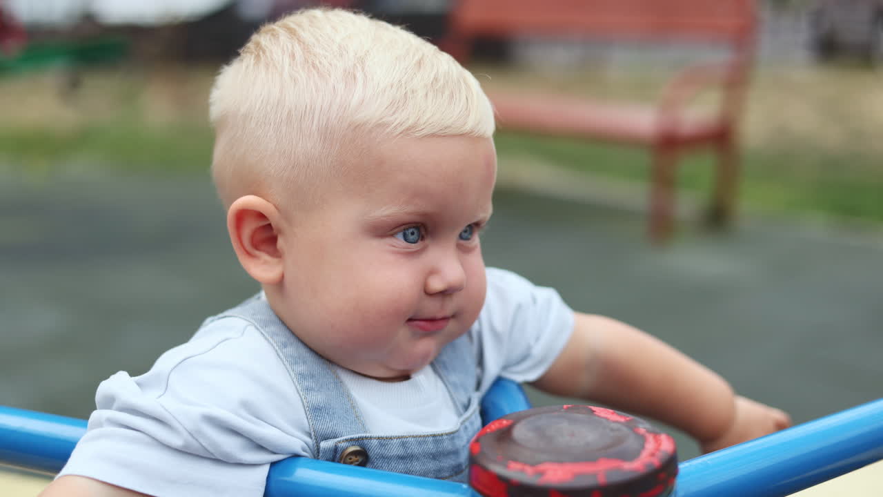 Little boy two years old. Child walking outdoors. Entertaining games for babies. Children's emotions on a walk with parents