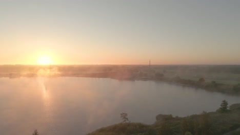 sunrise over a misty lake