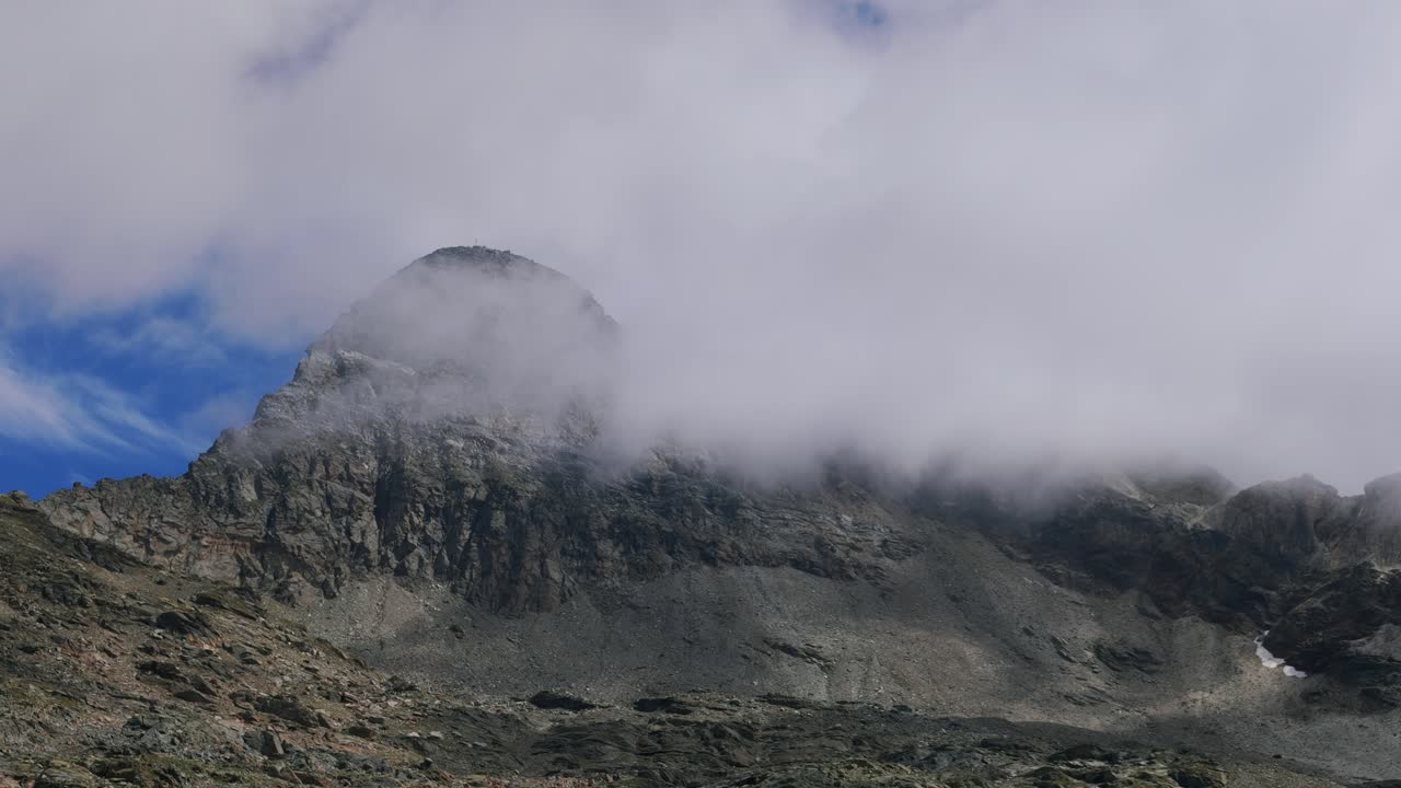 vista cinematográfica del pico de la montaña pizzo scalino con nubes