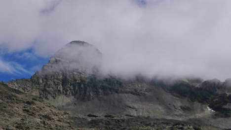 Cinematic-View-Of-Pizzo-Scalino-Mountain-Peak-With-Clouds