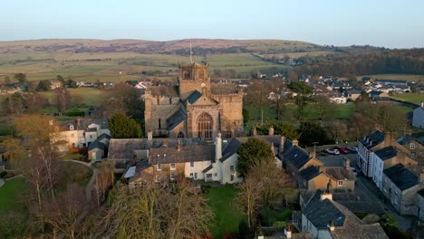 Aerial-footage-of-the-Medieval-village-of-Cartmel-in-the-English-Lake-District-it-has-a-rich-heritage,-and-varied-list-of-activities-for-visitors-and-tourists