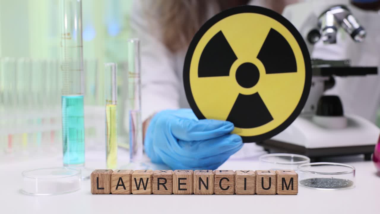 Scientist holding a radiation symbol in a laboratory with Lawrencium blocks