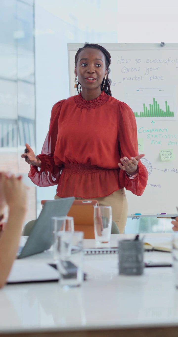 Businesswoman Presenting Marketing Strategies to Colleagues in Office